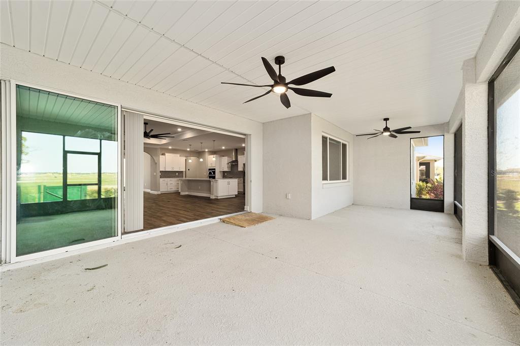 8176 Southwest 98th Terrace Road Ocala, FL 34481 - Photo 53 of 62 a view of a big room with wooden floor and a ceiling fan