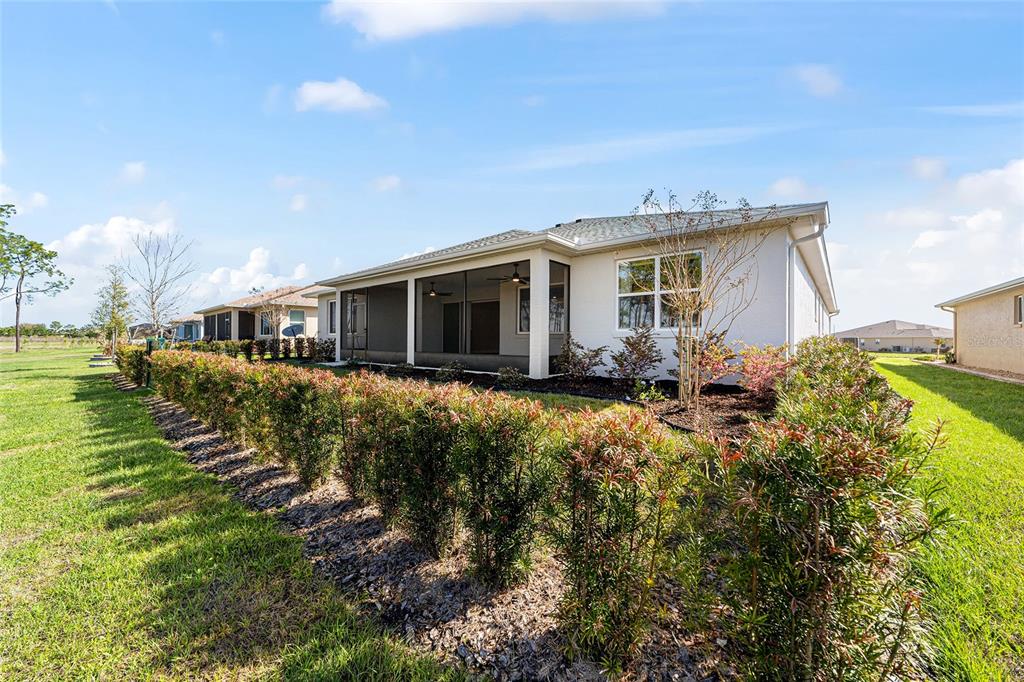 8176 Southwest 98th Terrace Road Ocala, FL 34481 - Photo 59 of 62 a front view of house with yard and trees in the background