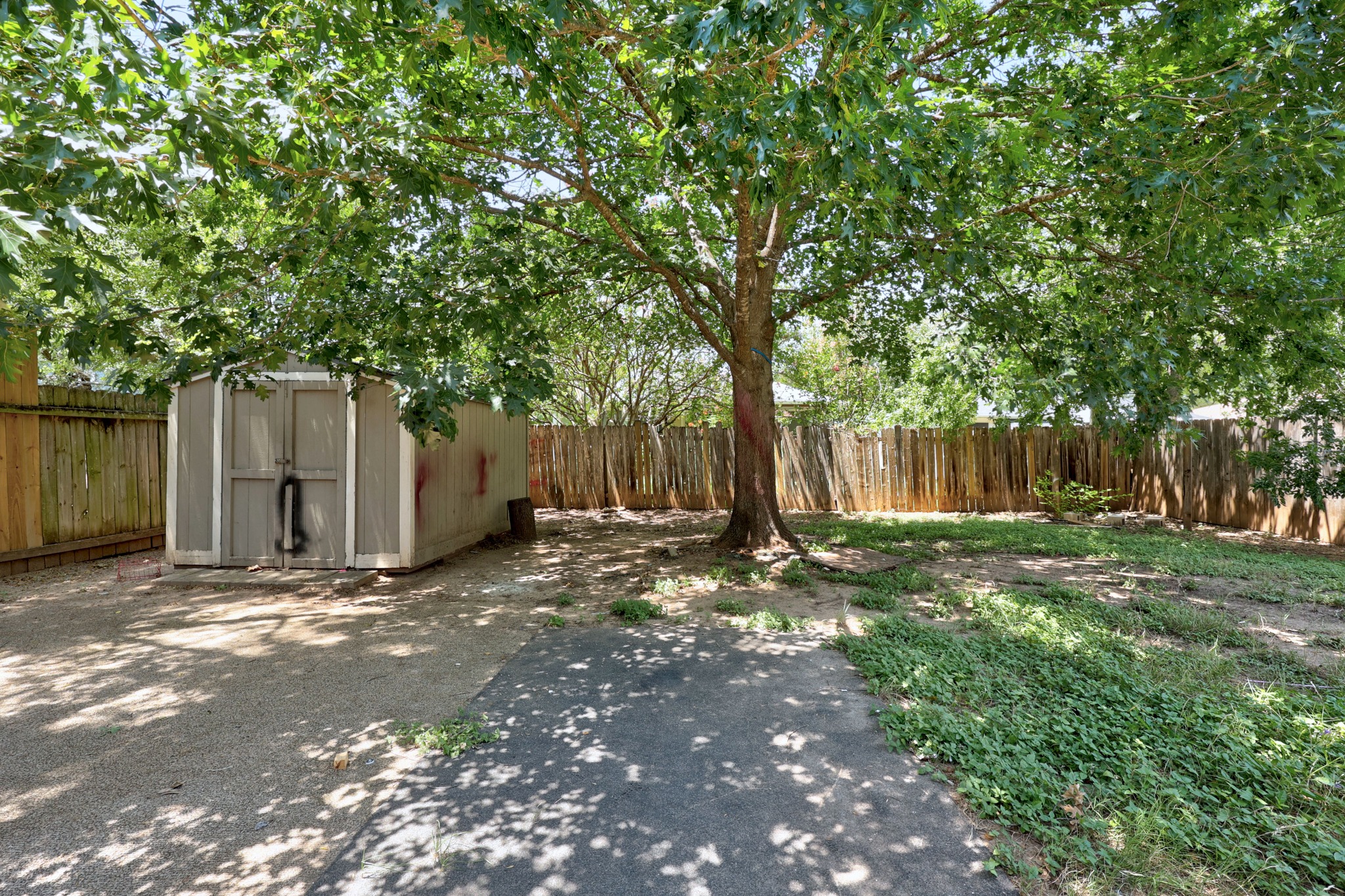 1806 Rusty Nail Loop Round Rock, TX 78681 - Photo 26 of 28 A fully fenced backyard offers a mature shade tree and a useful storage shed.