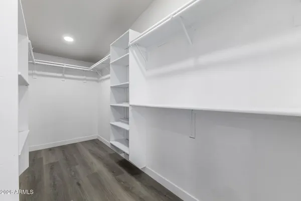 a view of walk in closet with empty racks