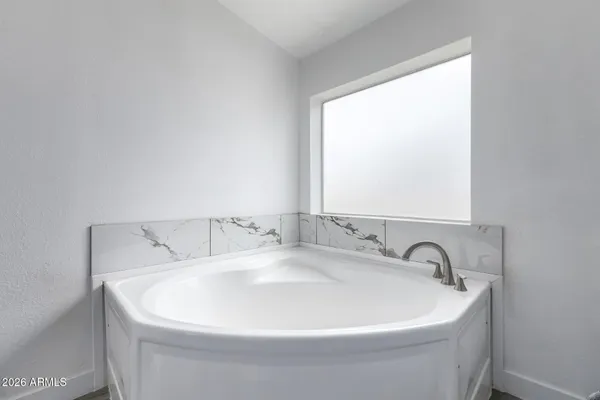 a white bath tub sitting in a bathroom