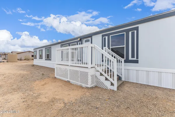 a view of a house with wooden fence