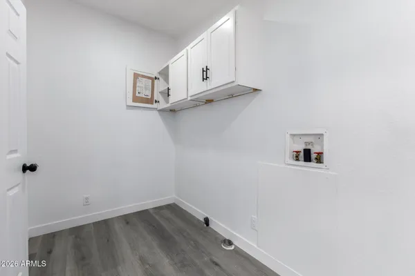 a view of storage and utility room with wooden floor