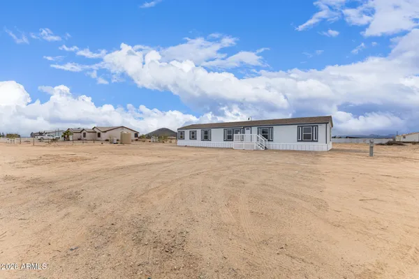 a view of house with yard and ocean view