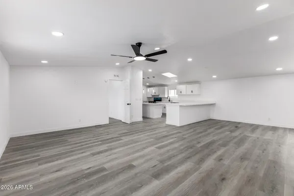 a view of a kitchen with a sink and a ceiling fan