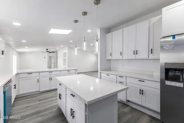 a kitchen with a sink stove and white cabinets