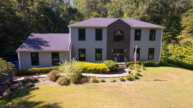 a front view of a house with a yard outdoor seating and plants