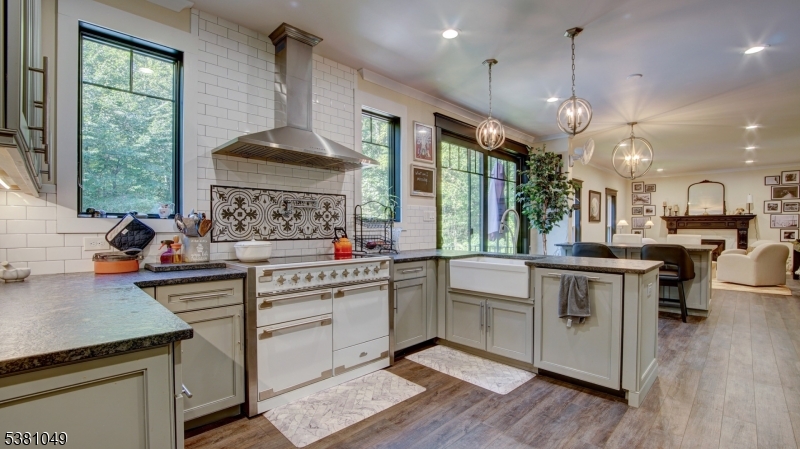 119 Broadway Road Cranbury, NJ 08512 - Photo 4 of 26 a kitchen with stainless steel appliances granite countertop a stove a sink dishwasher a refrigerator and a dining table with wooden floor