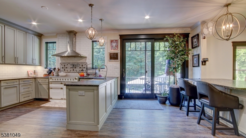 119 Broadway Road Cranbury, NJ 08512 - Photo 6 of 26 a kitchen with kitchen island granite countertop a sink stove and wooden cabinets