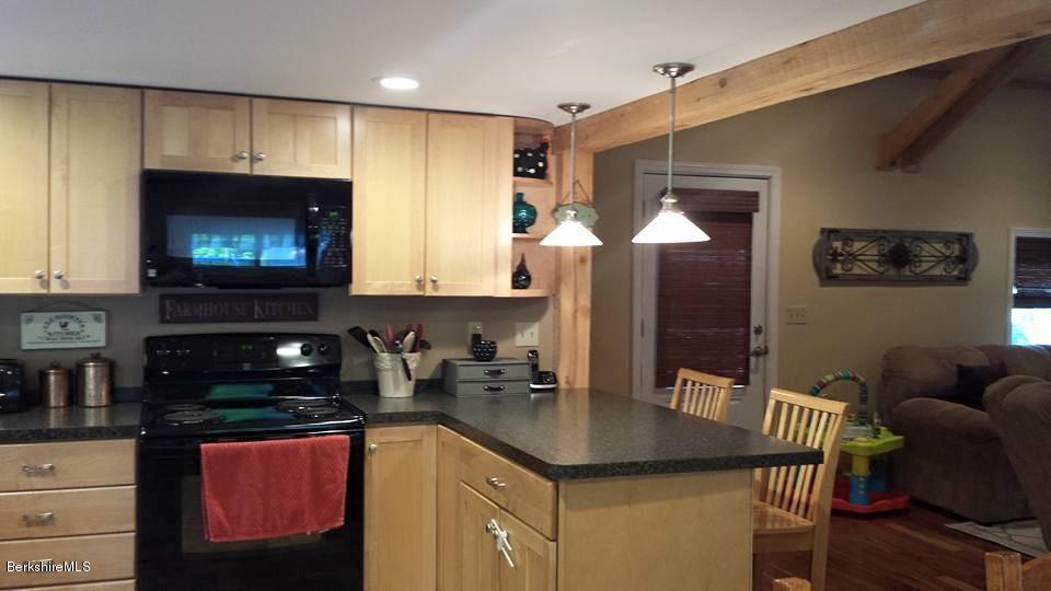 1288 Old Rte 9 Windsor, MA 01270 - Photo 10 of 21 a kitchen with stainless steel appliances granite countertop a sink a microwave refrigerator and chairs