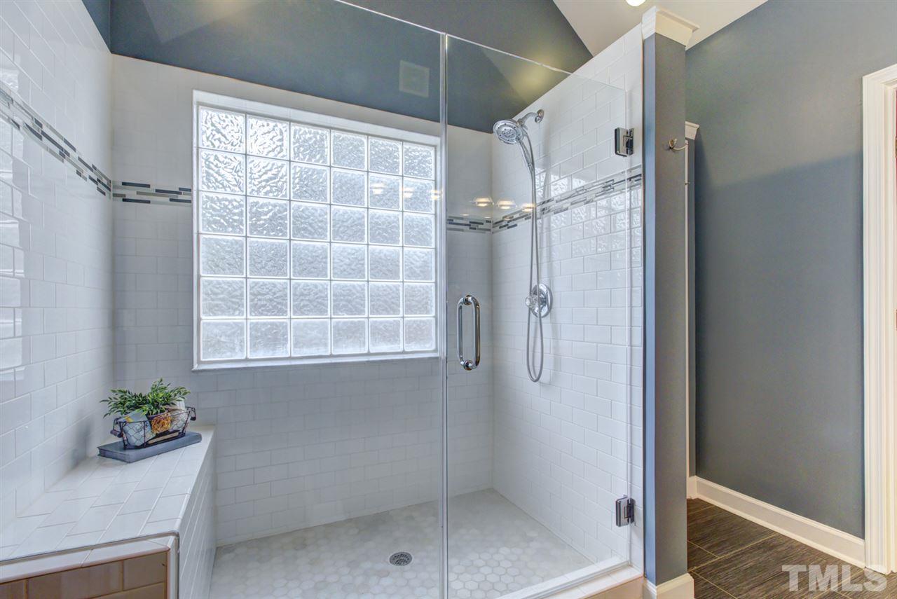1403 Haventree Road Durham, NC 27713 - Photo 5 of 18 Beautiful oversize walk-in tile shower with large glass window brings in a lot of natural light. This along with a dual vanity, and a large linen closet - everything you need to prepare for the day!