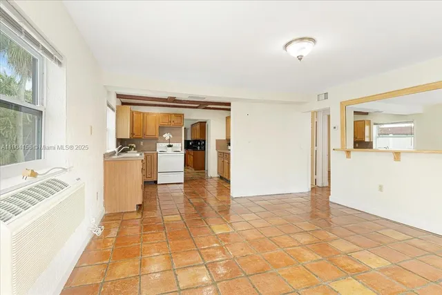 a kitchen with a sink cabinets and window