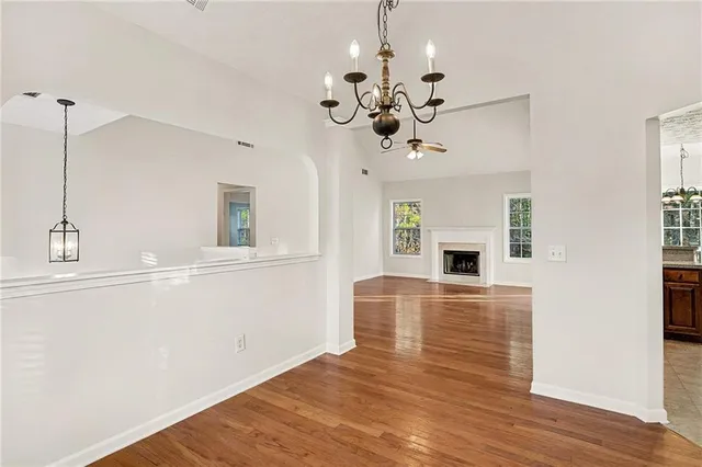 a view of a livingroom with a ceiling fan window and wooden floor