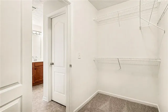 a view of walk in closet with empty racks