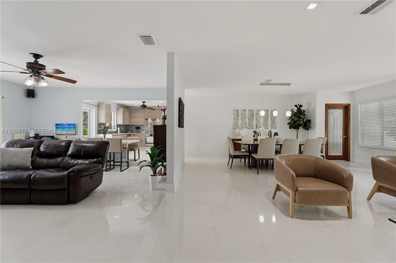 9641 Southwest 66th Street Miami, FL 33173 - Photo 14 of 57 a living room with furniture and a chandelier