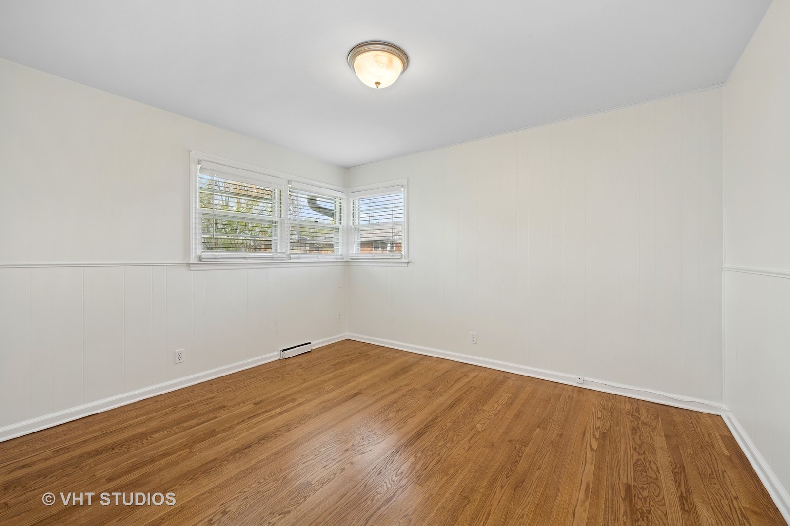 54 Burton Avenue Cary, IL 60013 - Photo 11 of 20 an empty room with wooden floor and windows
