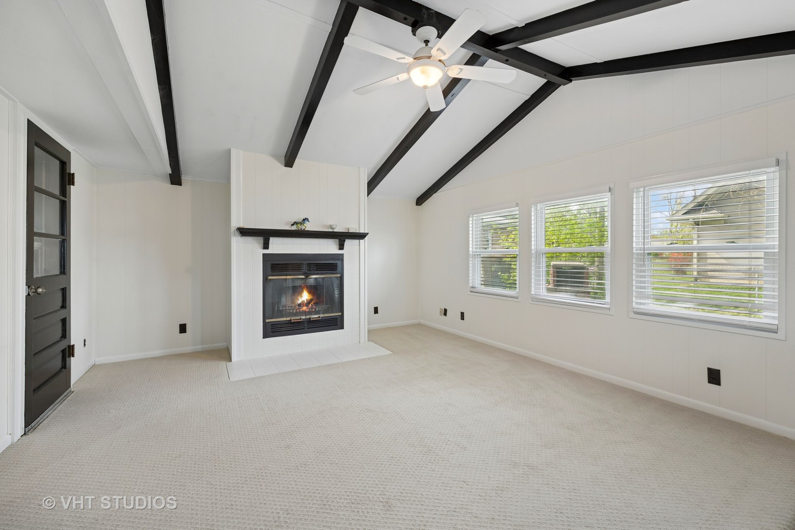 54 Burton Avenue Cary, IL 60013 - Photo 9 of 20 a view of an empty room with a fireplace and a window