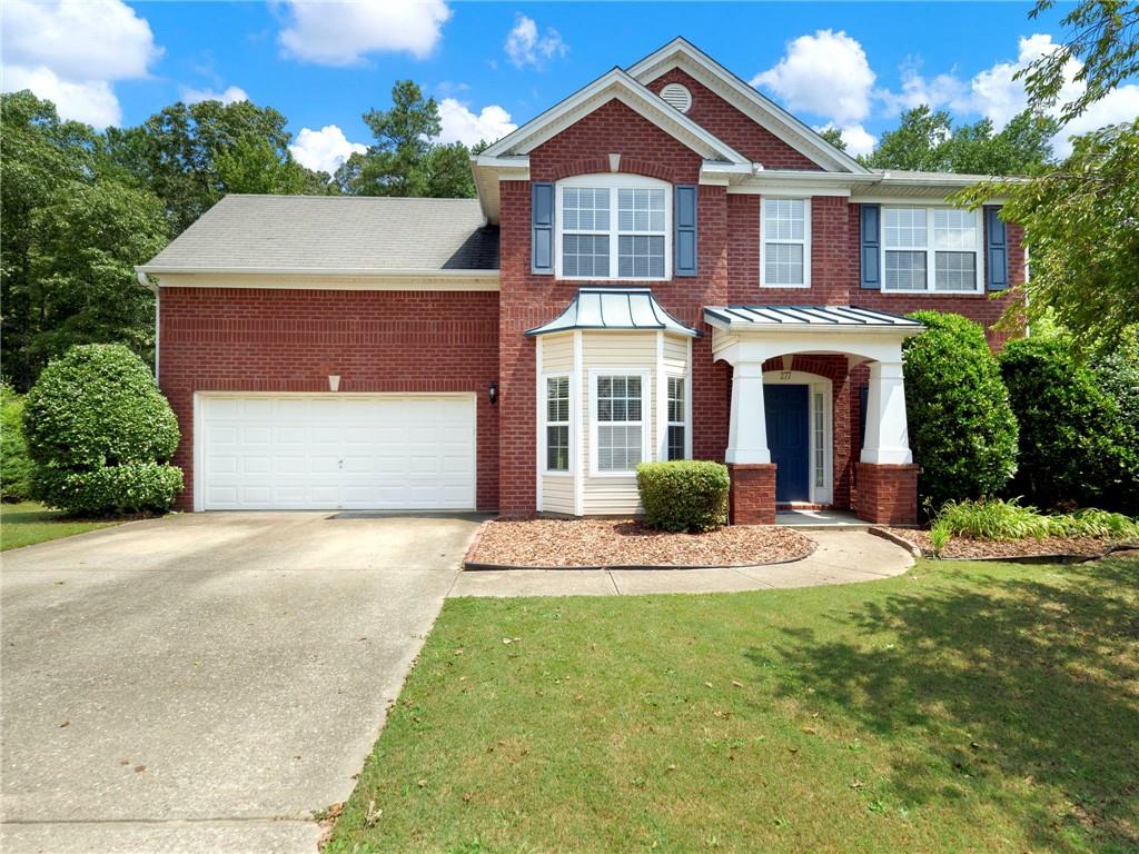 277 Murray Park Drive Dacula, GA 30019 - Photo 1 of 1 a front view of a house with a yard and garage