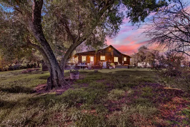 a view of house with outdoor space and trees