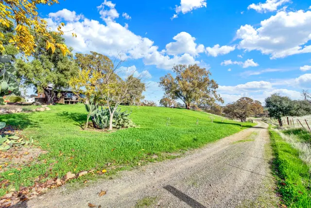 a view of a house with backyard and sitting area