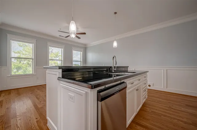 a kitchen with a stove and a wooden floors
