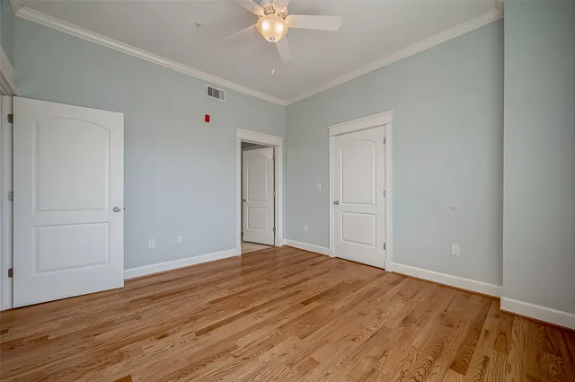 a view of an empty room with wooden floor