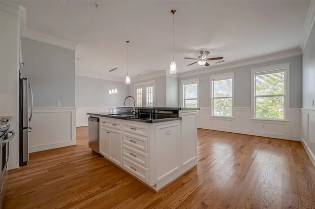a kitchen with stainless steel appliances granite countertop a stove a sink and a refrigerator