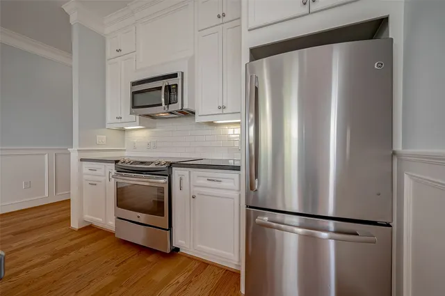 a kitchen with stainless steel appliances a refrigerator microwave and sink