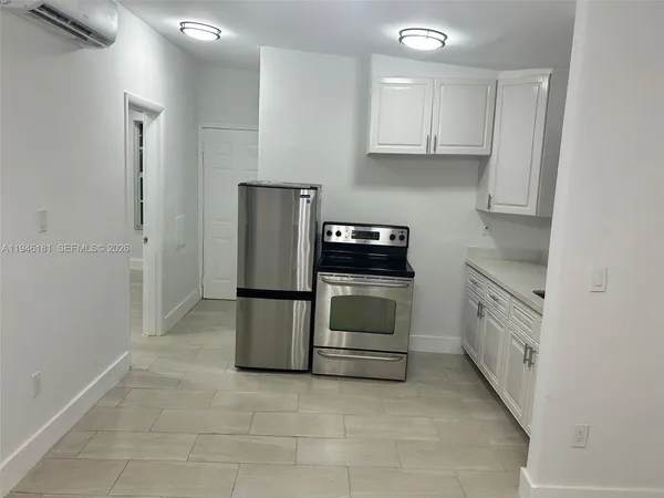 a kitchen with a stove top oven and cabinets