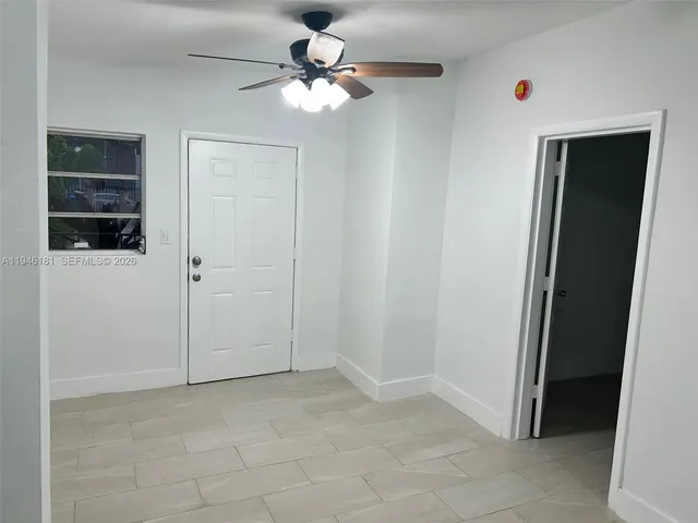 an empty room with closet and a bathroom view