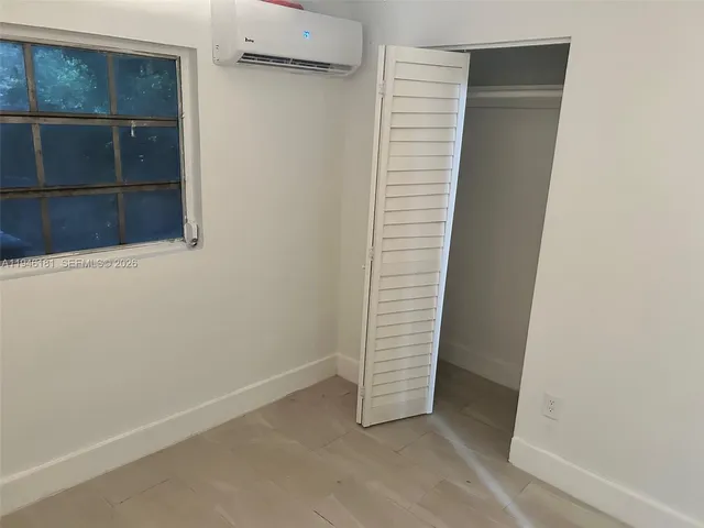 a bathroom with a shower and a window