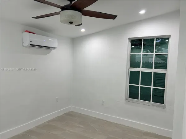 an empty room with windows and closet