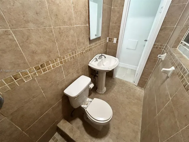 a view of a yard with wooden fence