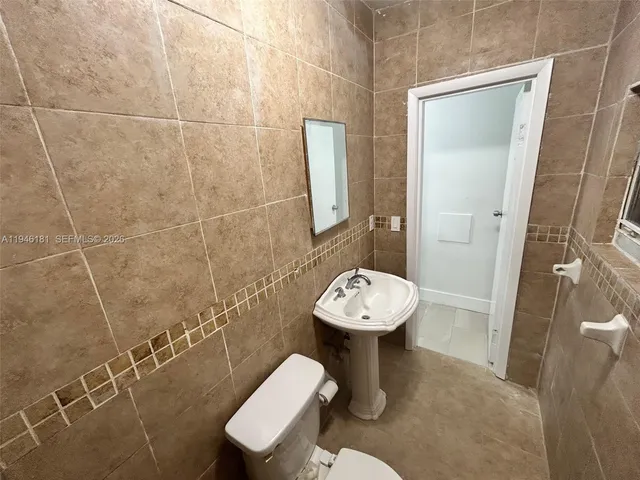 a view of a backyard with table and chairs and a large tree