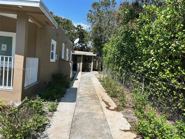 a front view of a house with yard and green space