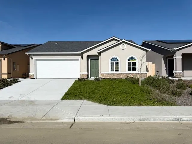 a view of a house with a yard and a garage