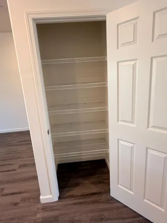 a view of walk in closet with empty racks