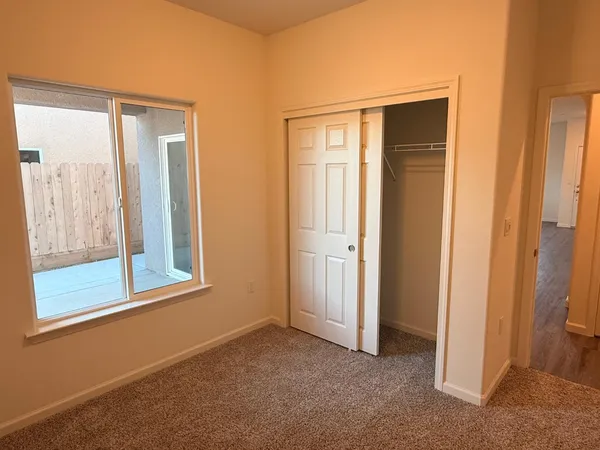an empty room with windows and closet