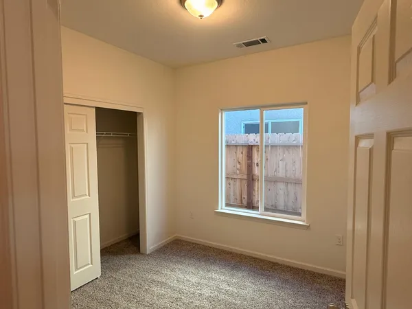 a view of an empty room with a window
