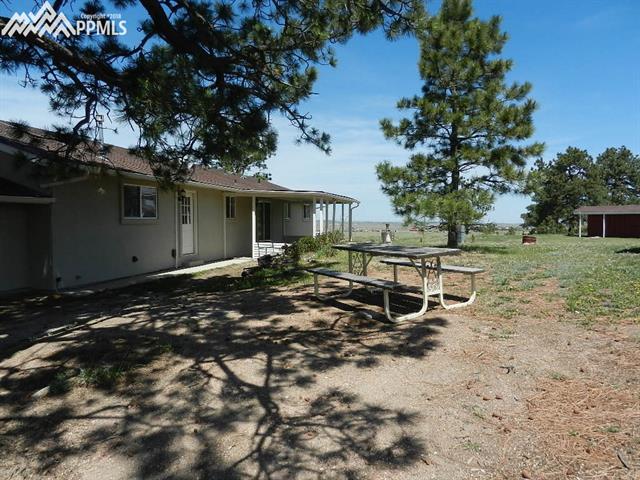 16555 Bar X Road Colorado Springs, CO 80908 - Photo 27 of 36 This is around the back. You have extra space on a covered patio and a picnic area.