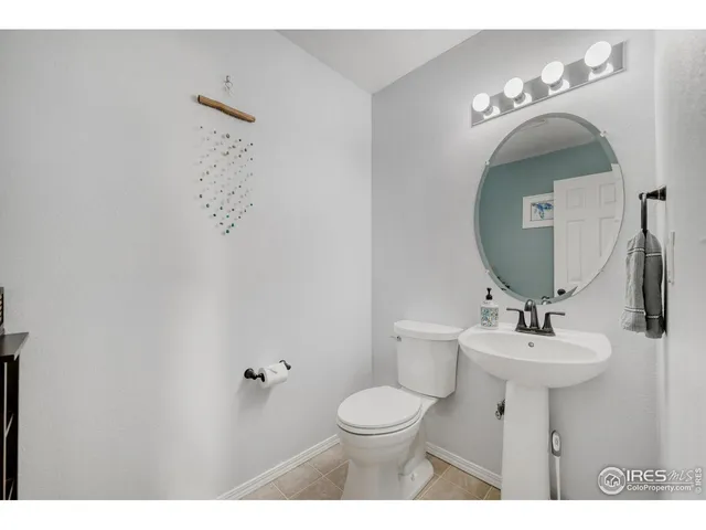 a bathroom with a sink mirror and toilet