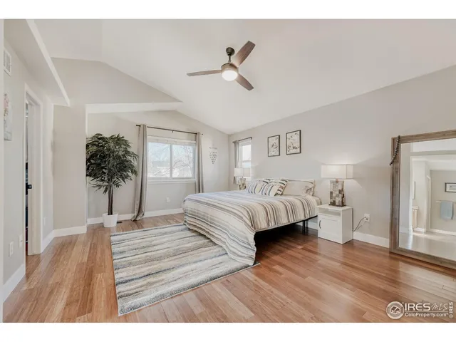 a bedroom with a bed and a potted plant