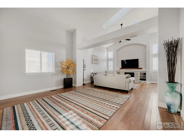 a view of a bedroom with furniture and flat screen tv