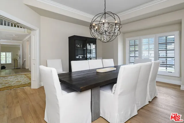 a view of a dining room with furniture wooden floor and chandelier