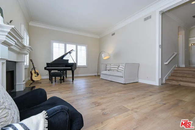 a living room with furniture and a piano