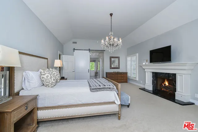 a bedroom with bed and a fireplace