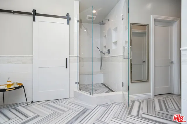 a bathroom with a shower and a mirror
