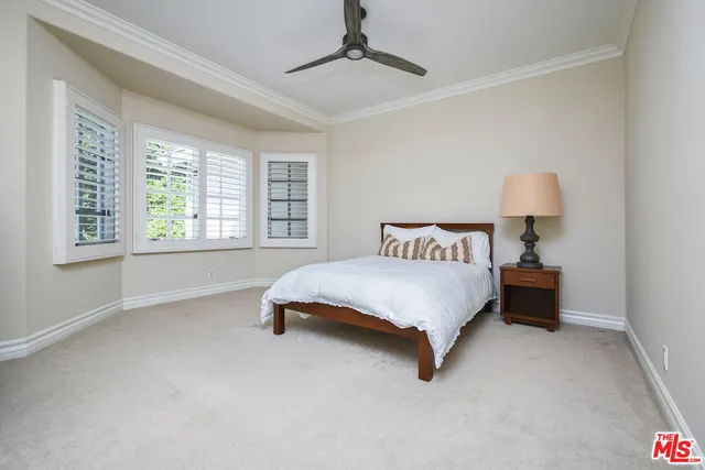 a bedroom with a bed and a lamp