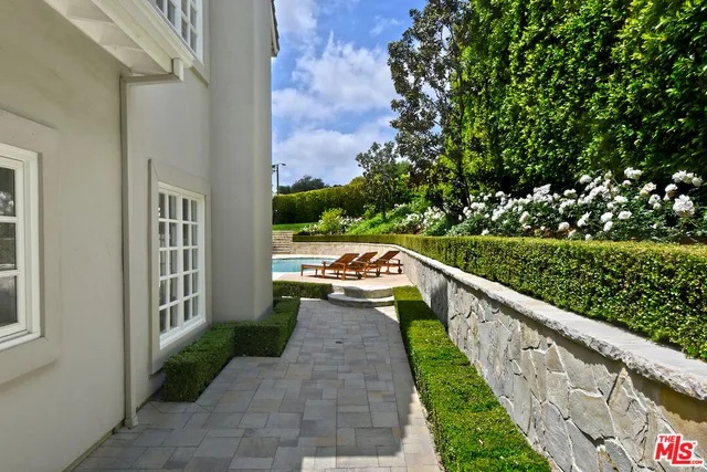 a view of a balcony with yard