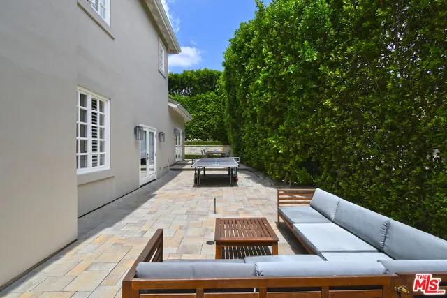 a view of a patio with table and chairs with wooden floor and fence